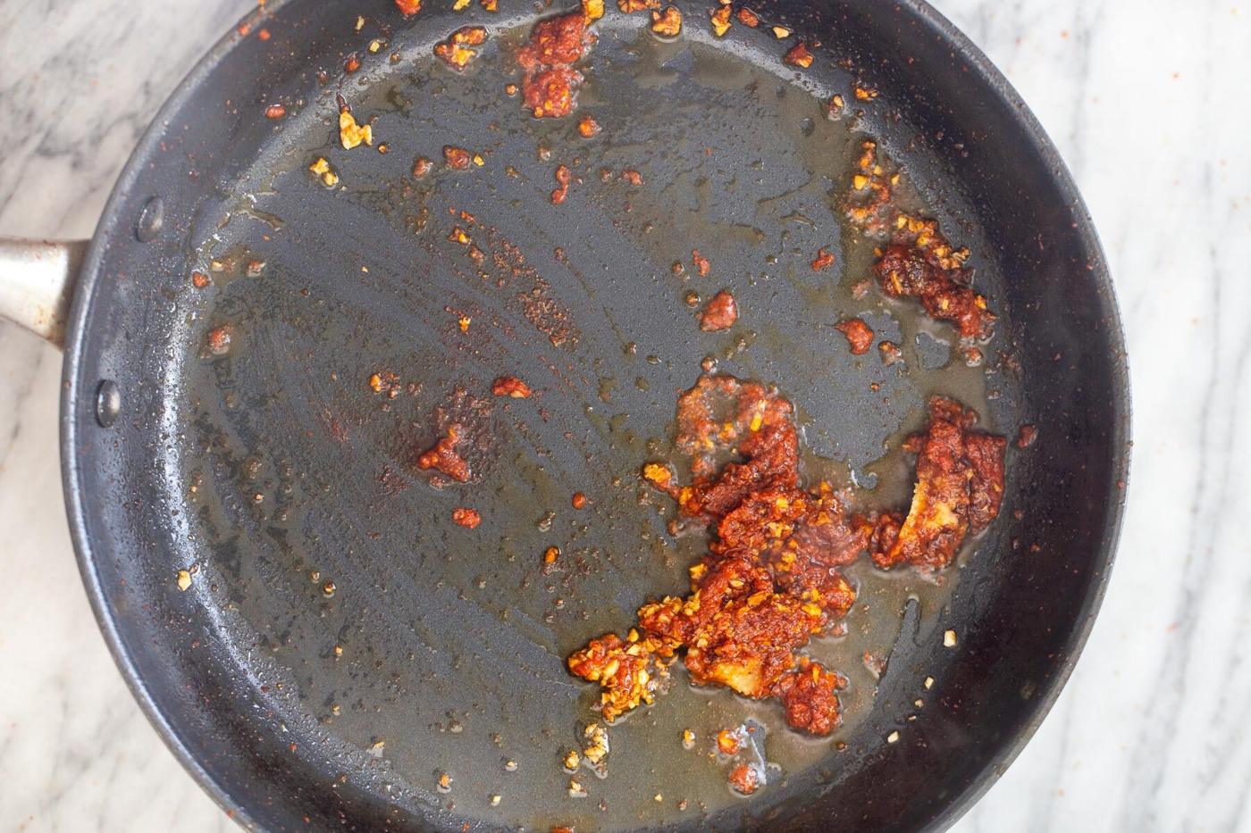 minced garlic and red curry paste in a saucepan