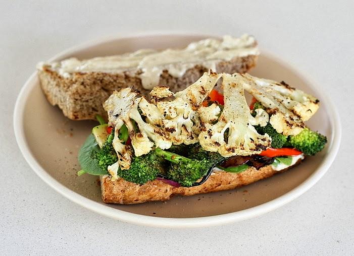 healthy almond flour sandwich bun topped with roasted cauliflower and broccoli florets