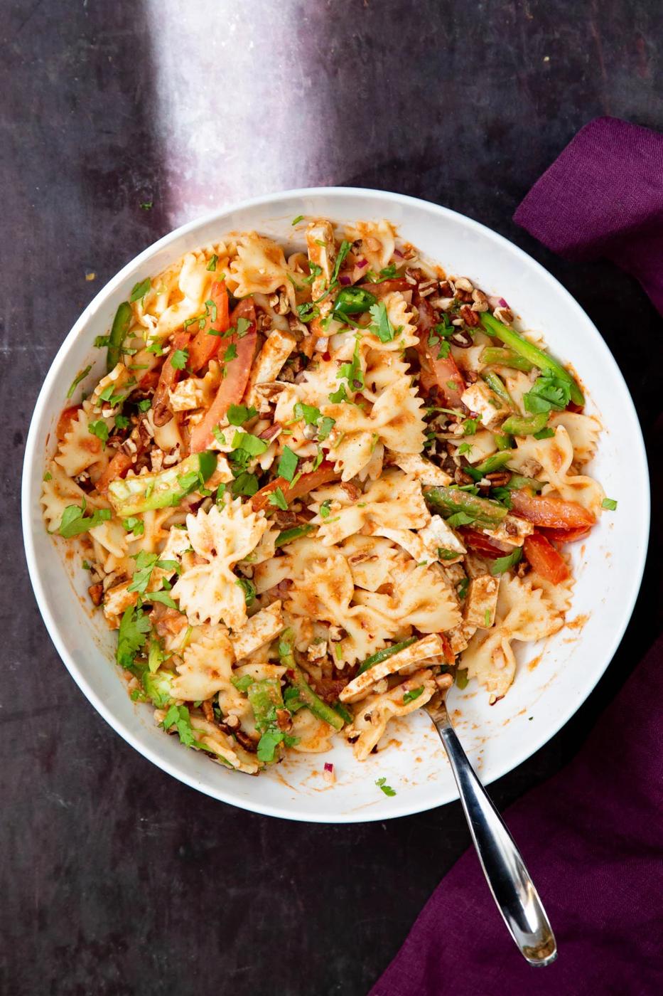 vegan tikka masala pasta salad sprinkled with chopped herbs