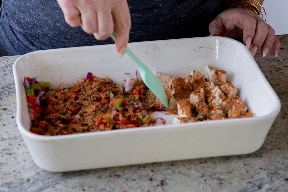 stirring spices into the tofu