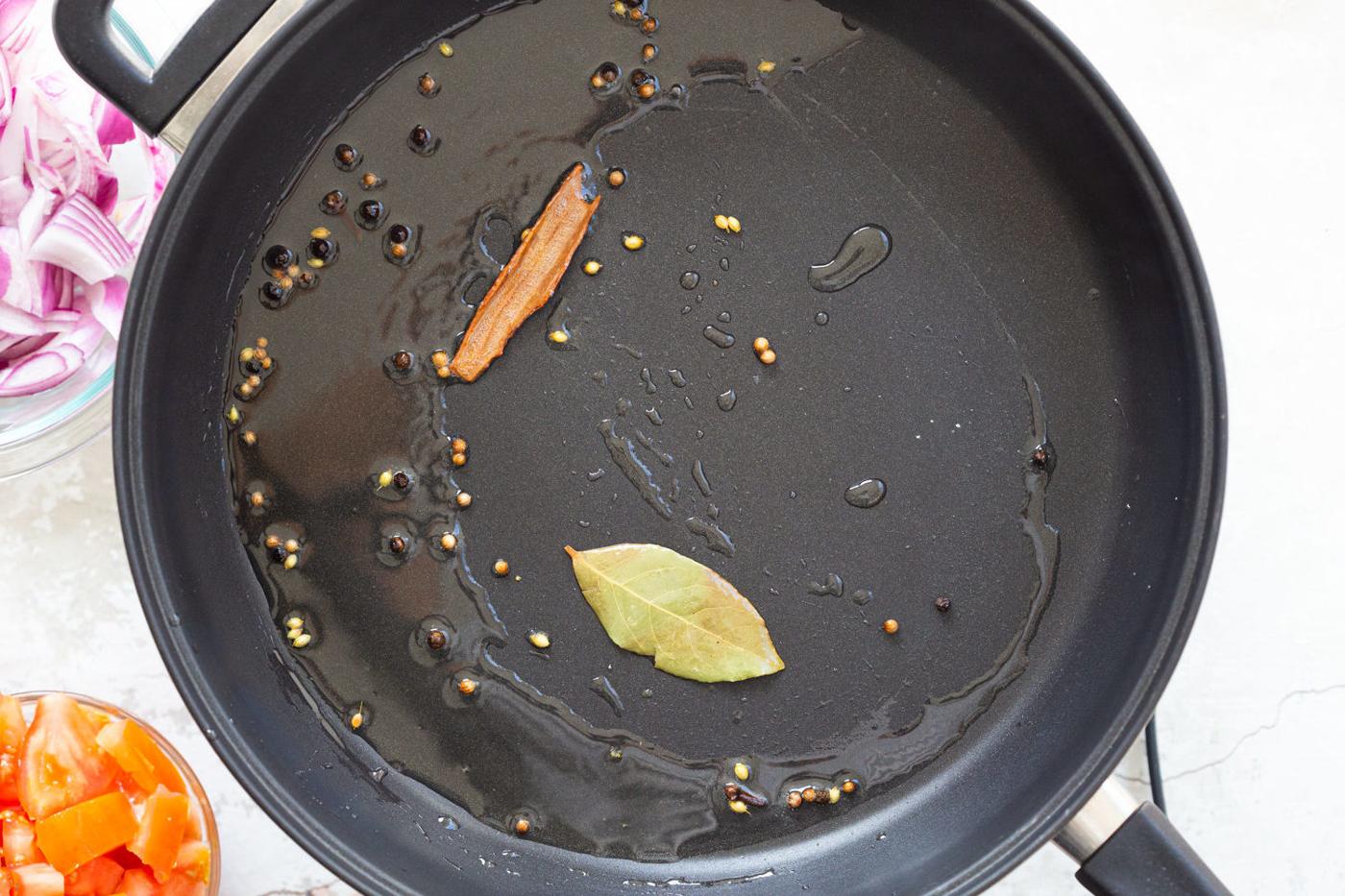 Spices for Kohlapuri sauce in black skillet