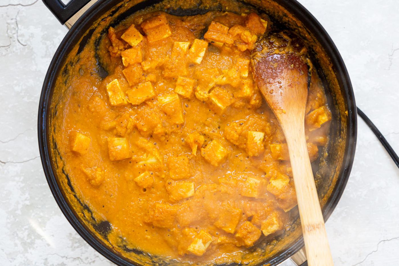Tofu and Cauliflower in kolhapuri Sauce in a Black skillet