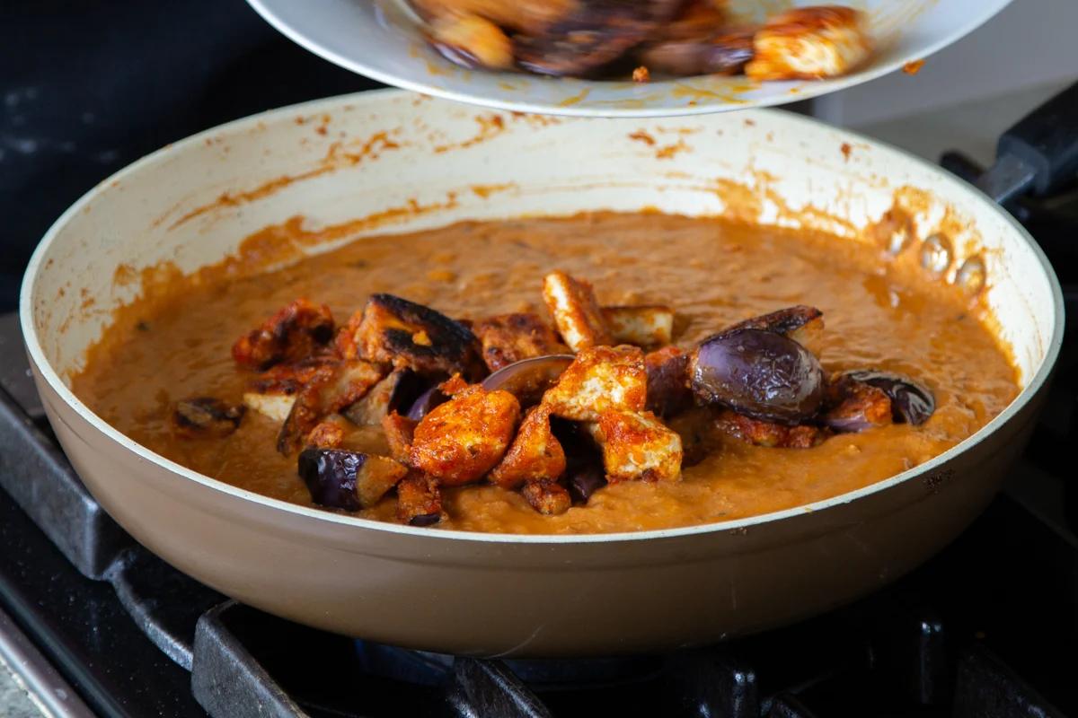adding the eggplant and tofu to the curry sauce