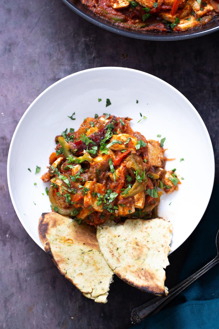overhead shot of a serving of vegan jalfrezi tofu curry served with flatbread