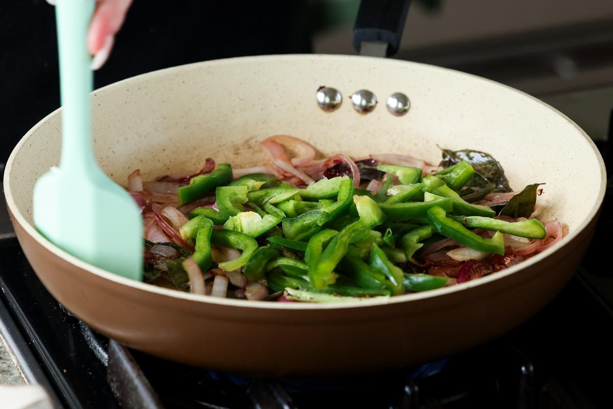 adding bell pepper to the pan