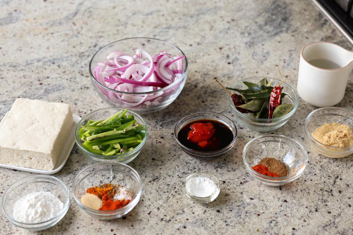 tofu, veggies, and other kondattam ingredients on the kitchen counter