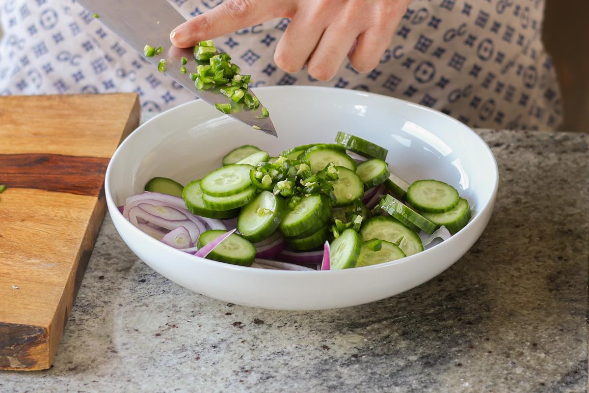 adding onions and veggies to a bowl