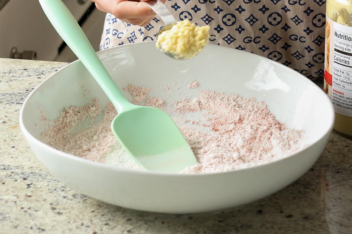 adding wet ingredients to the bowl