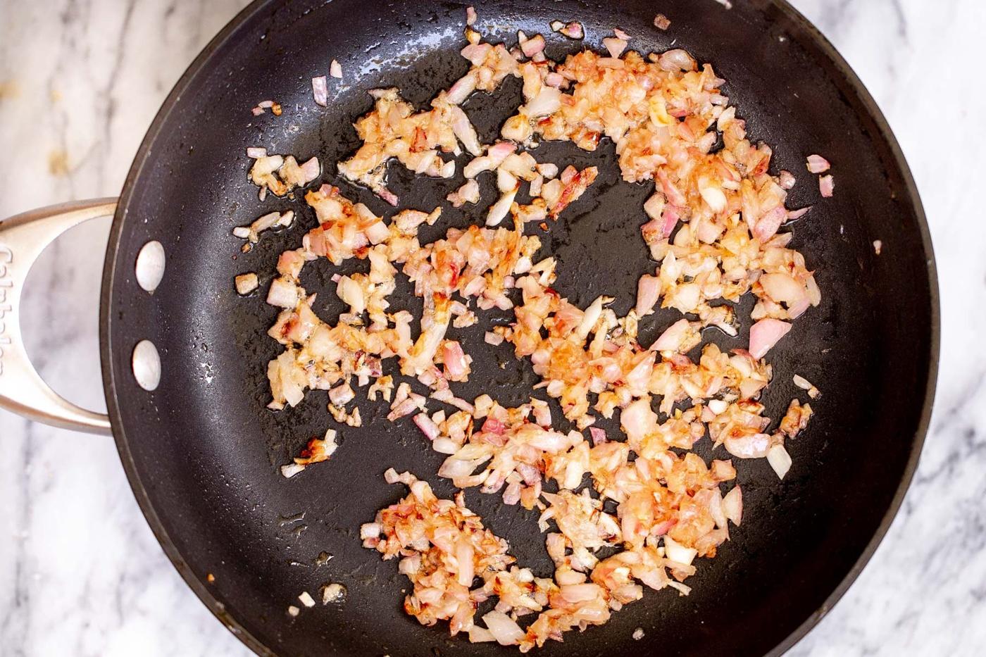 fried diced onions in a skillet