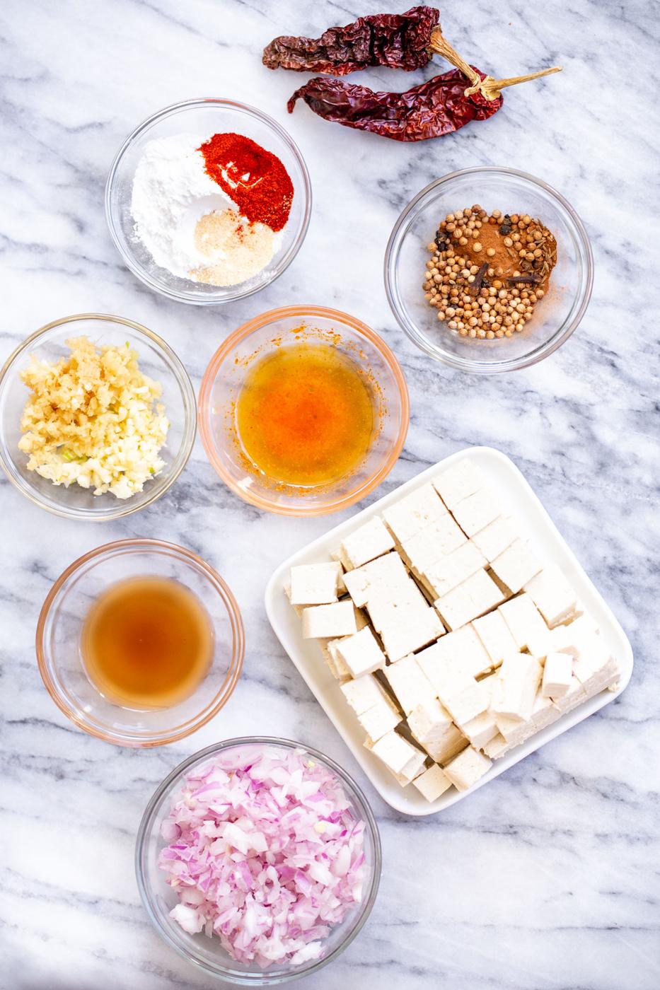 ingredients for vindaloo curry on a marble countertop