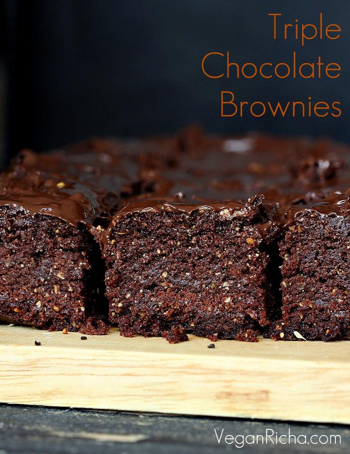 side view of Vegan Triple Chocolate Salted Caramel Brownies on a wooden board