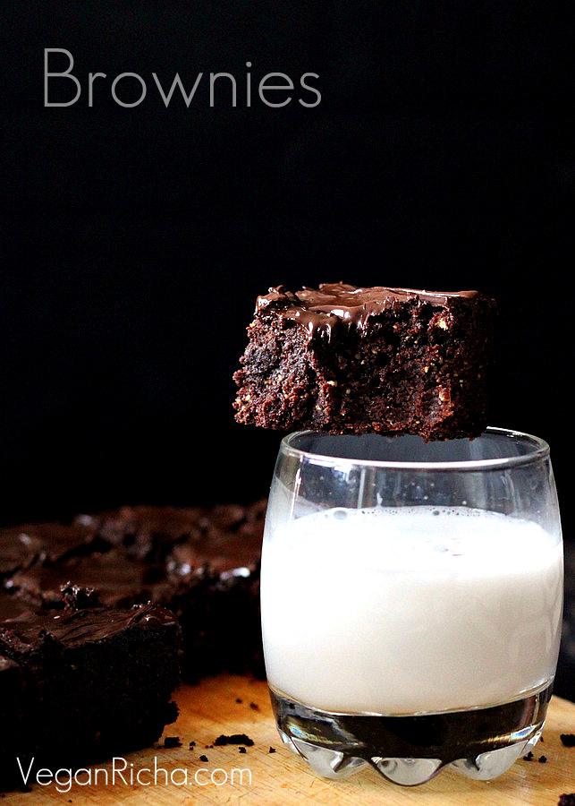 vegan triple chocolate salted caramel brownie sitting on the rim of a milk glass