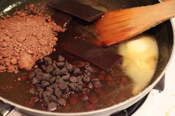 chocolate chips, chocolate and cocoa powder being added combined to make vegan brownies