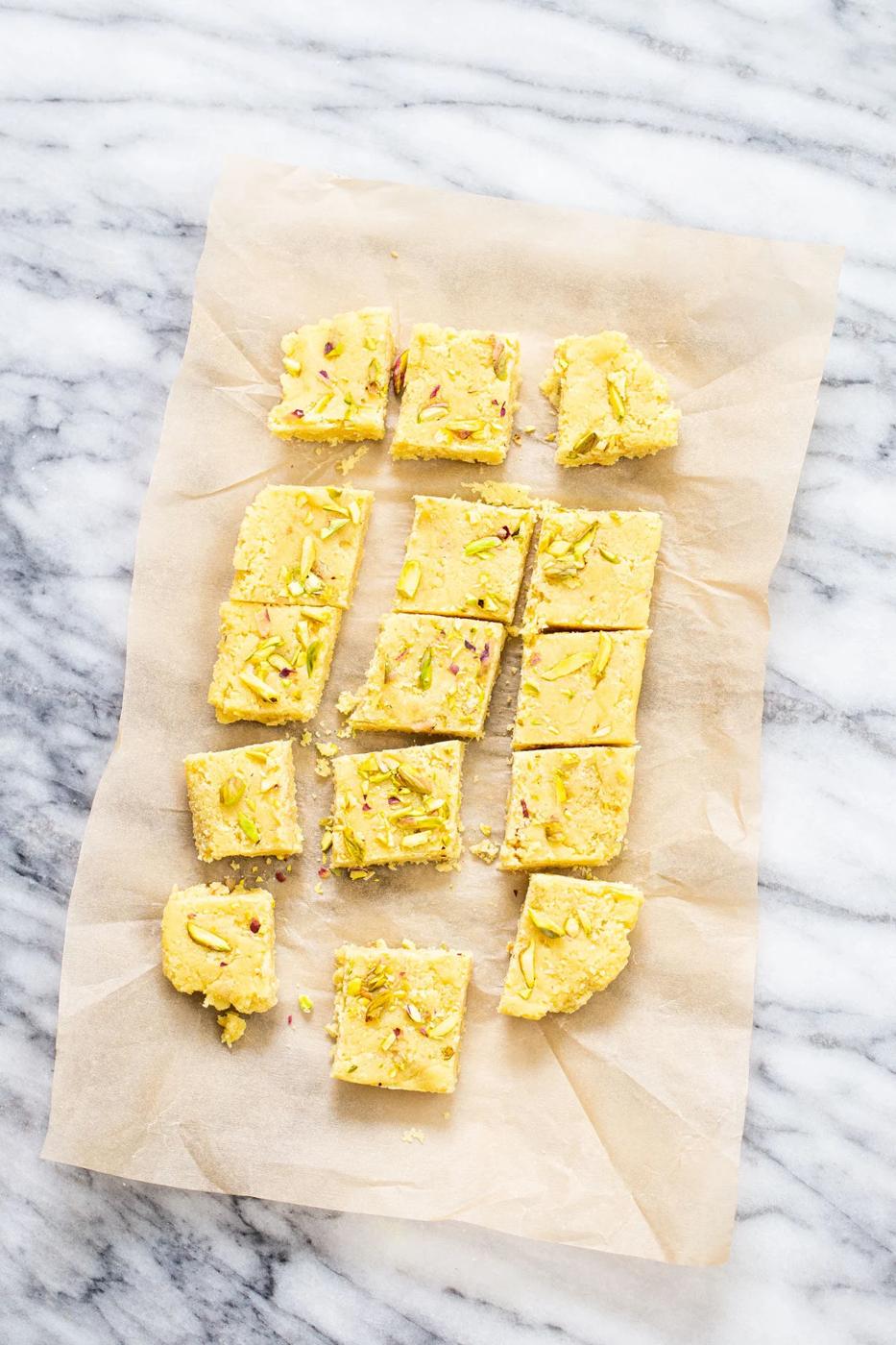 almond burfi on a piece of parchment paper cut into squares