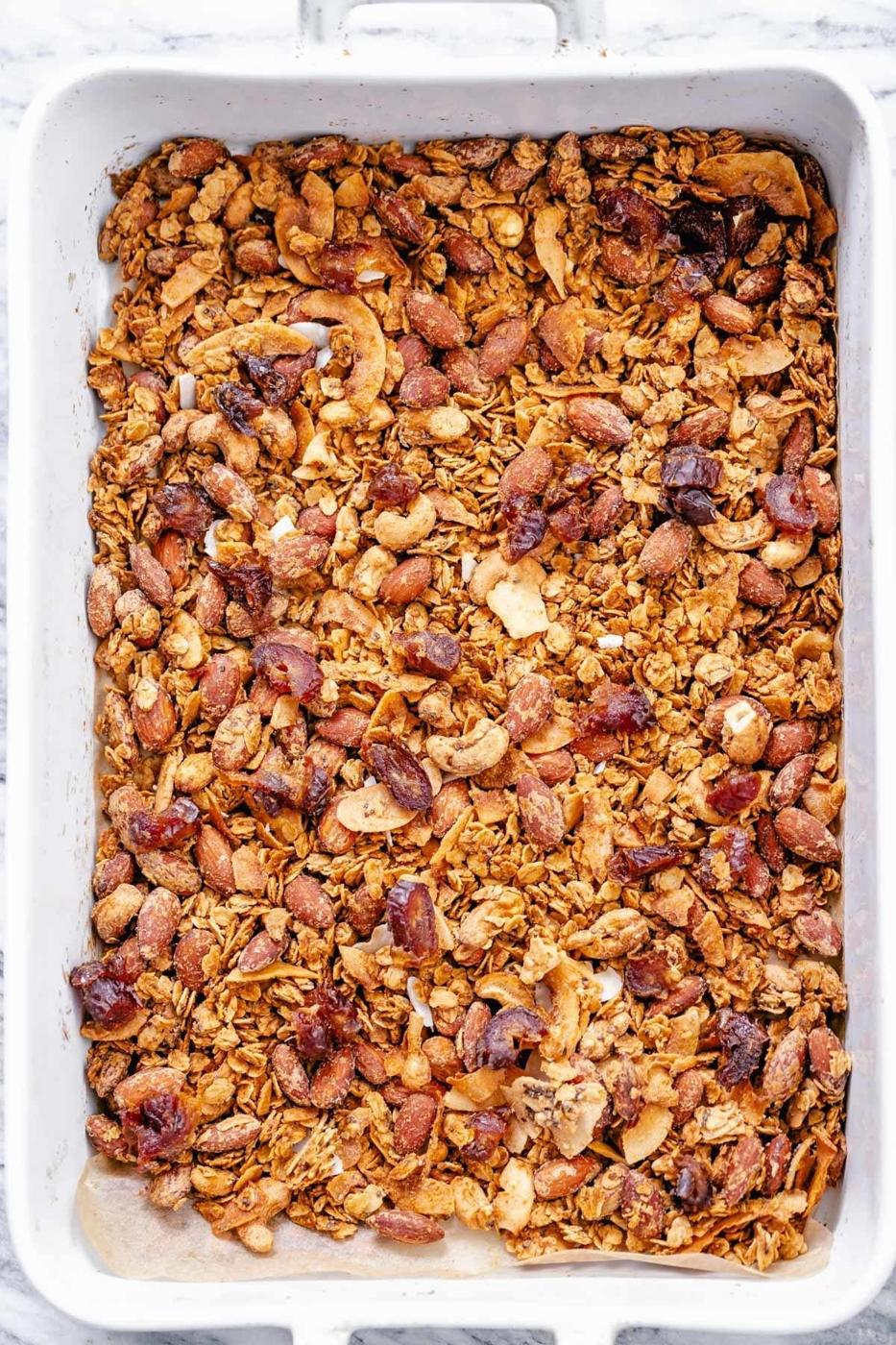 overhead shot of vegan baked coconut almond granola in a casserole dish