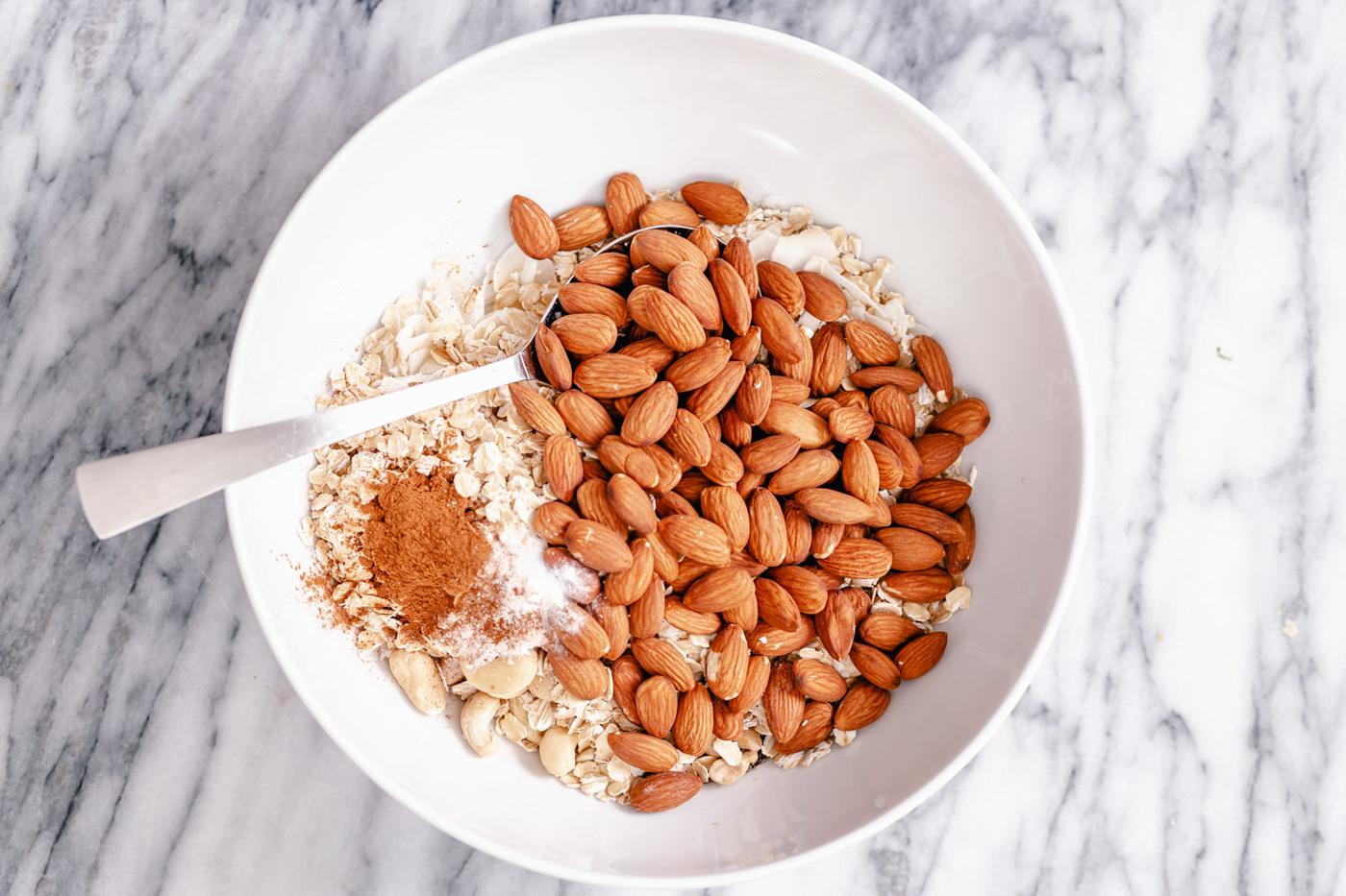a small bowl with dry ingredients needed for making vegan baked almond coconut granola