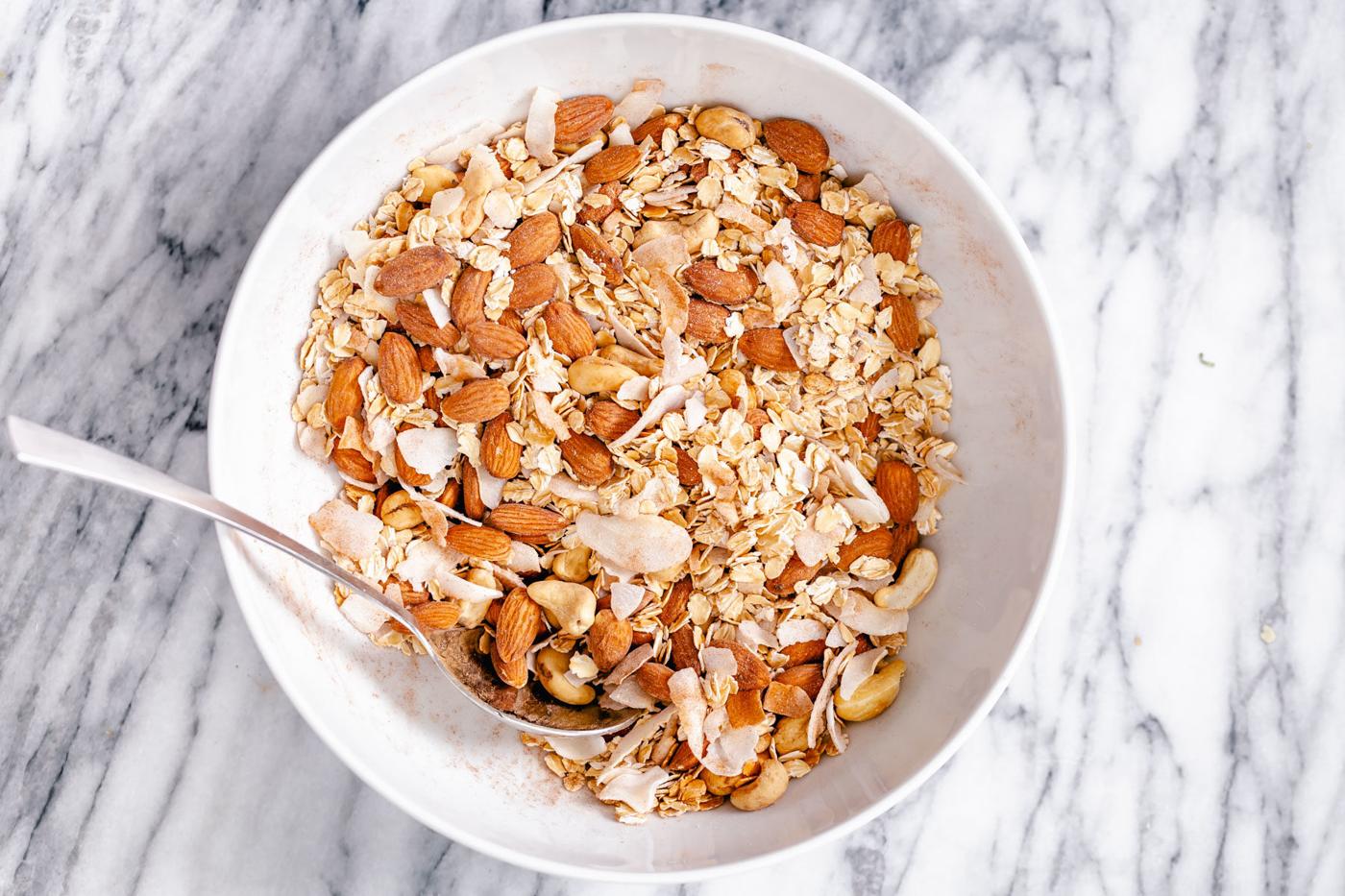 dry granola ingredients being mixed in a small bowl