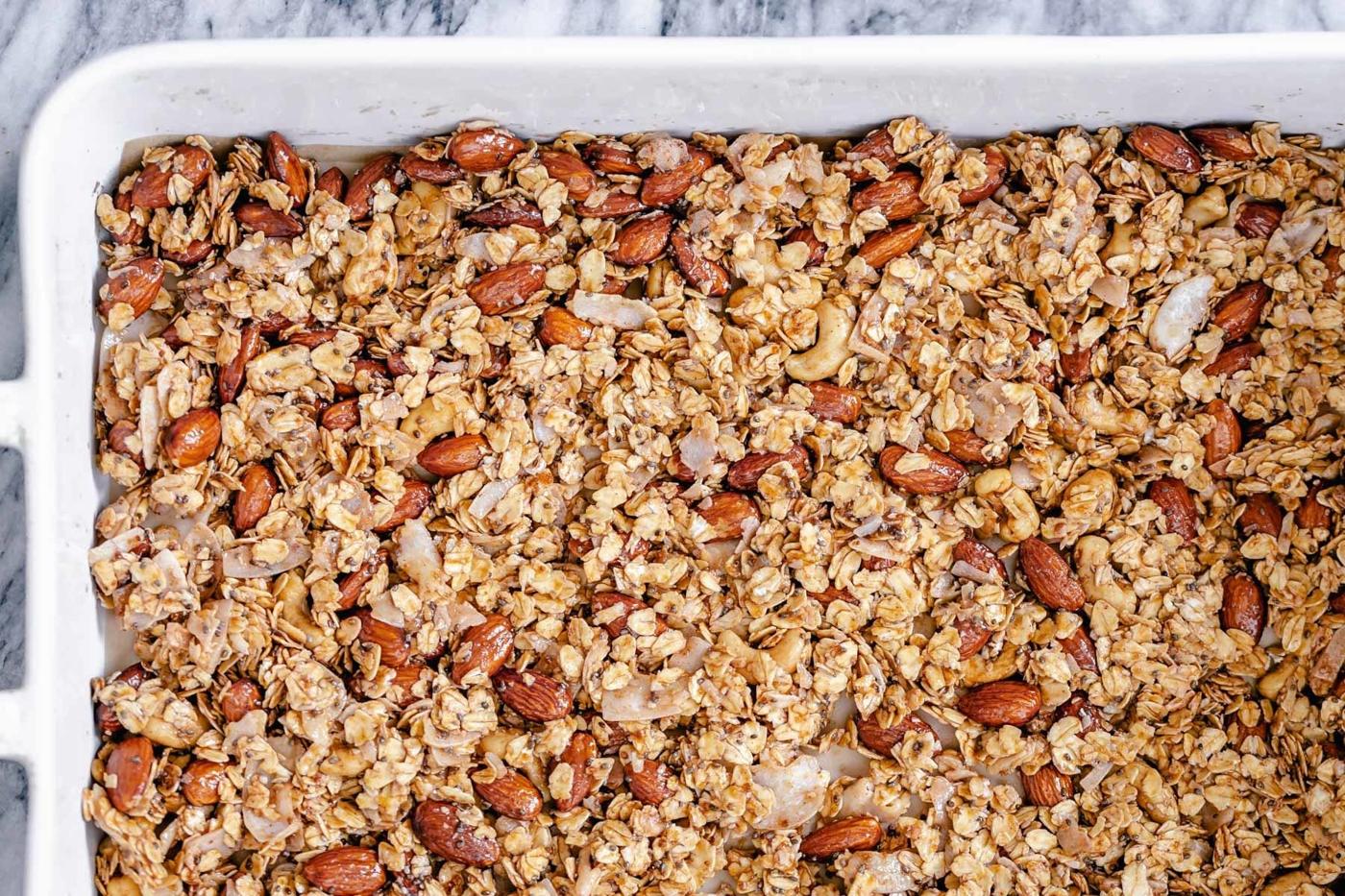 overhead shot of a casserole dish with baked almond coconut granola