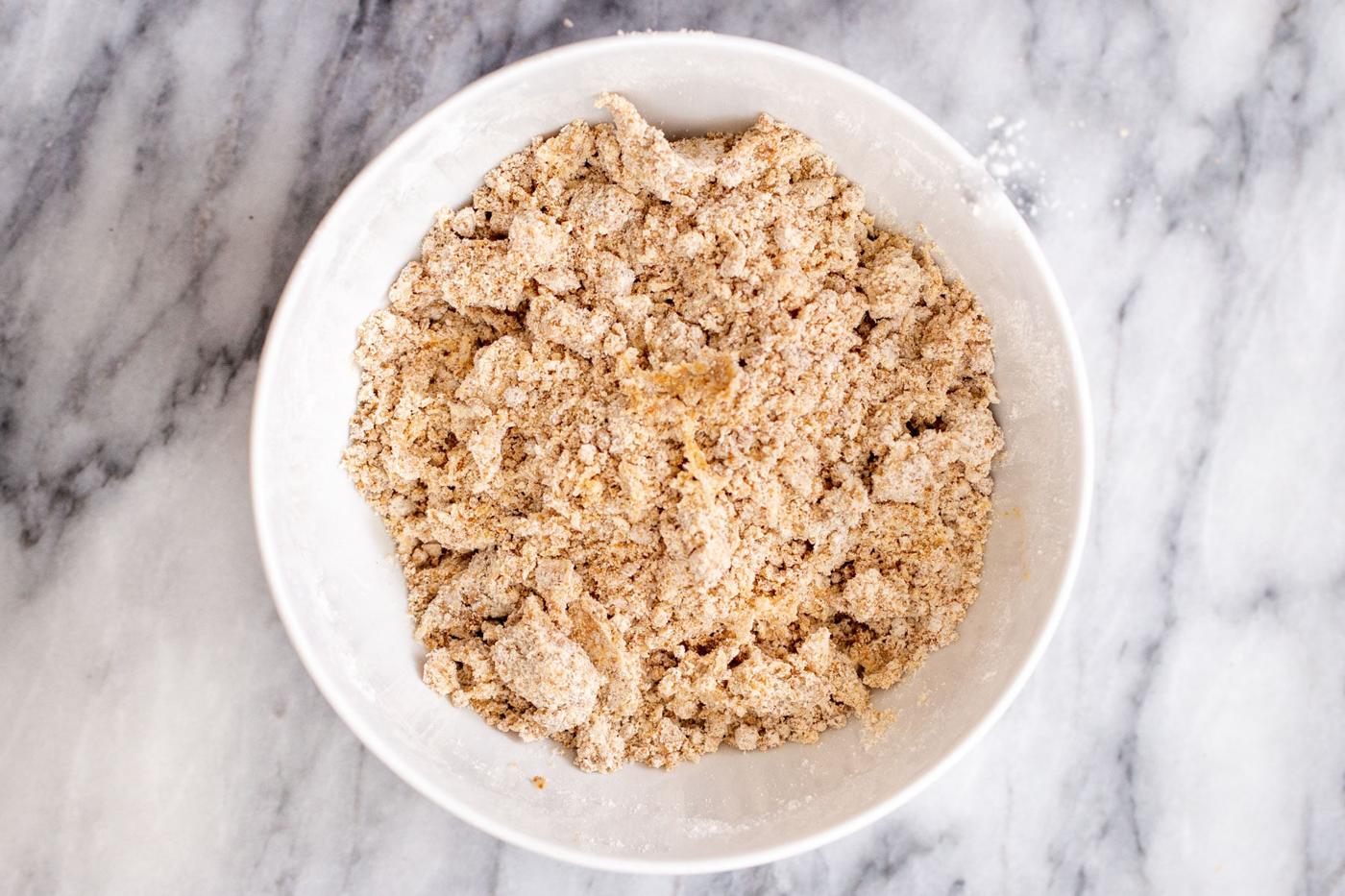 vegan apple pie bars crust in a white bowl