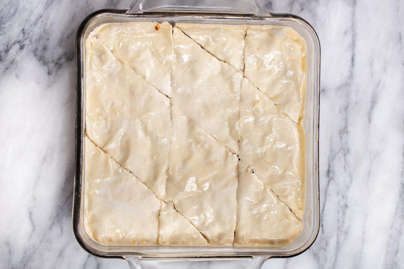 vegan baklava unbaked in a glass casserole dish