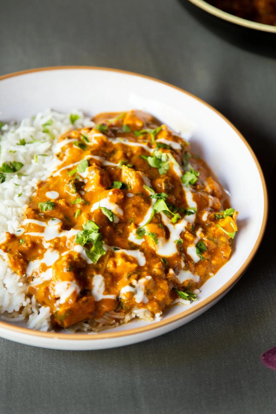a plate with vegan balti chicken with a side of rice