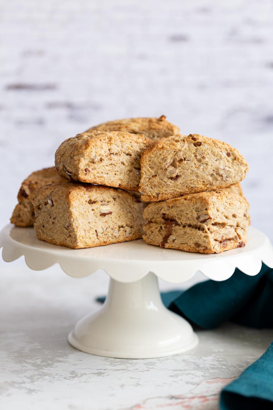 side view of vegan banana scones on a white cake stand
