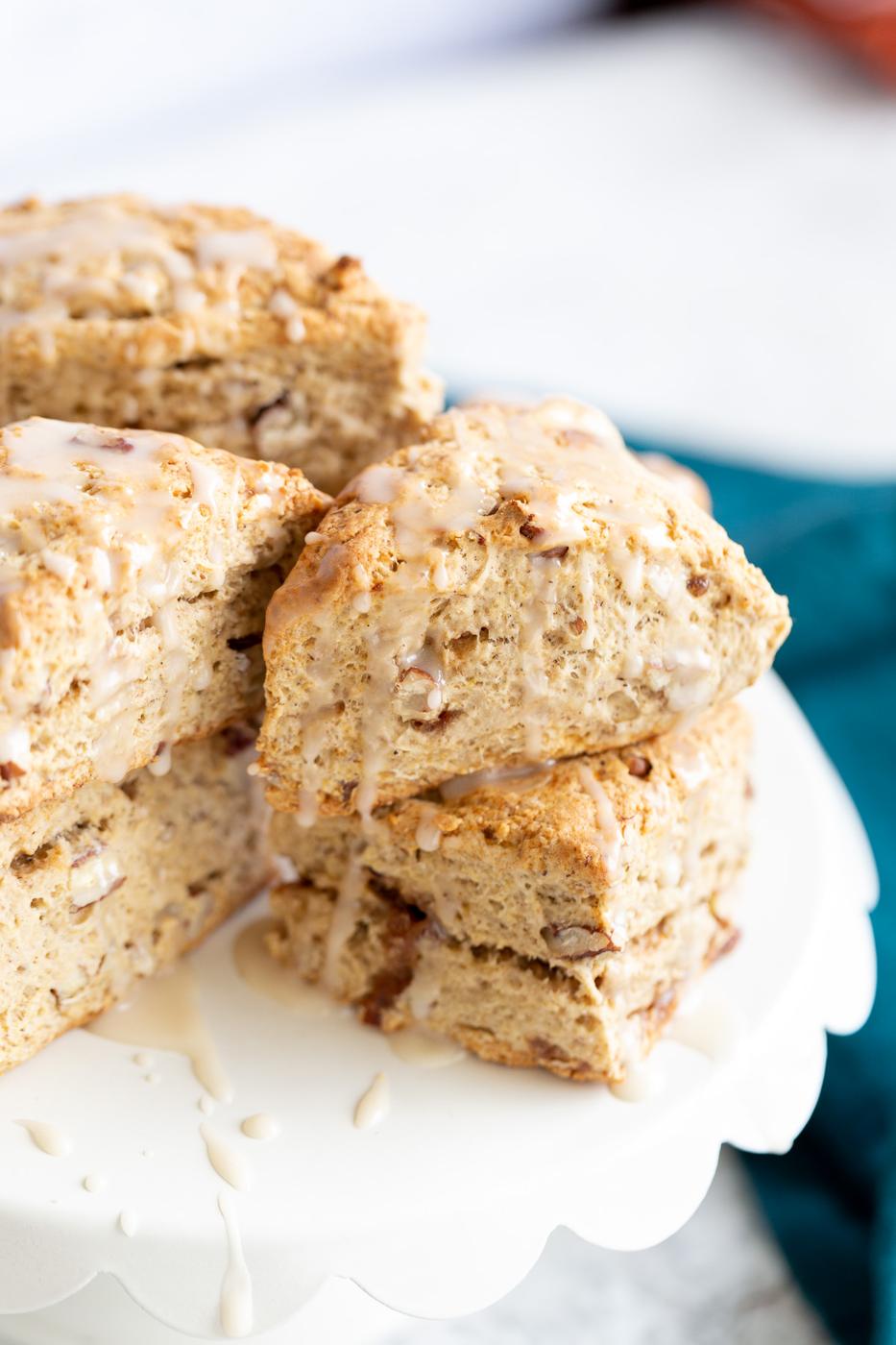side view of vegan banana scones on a white cake stand