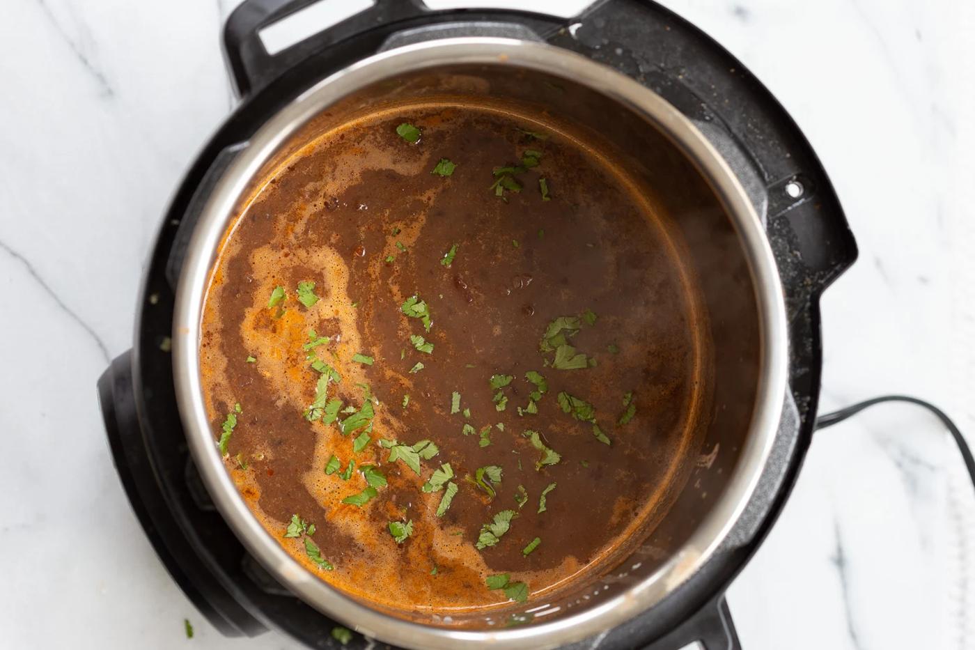 overhead shot of vegan black bean soup simmering in an Instant Pot