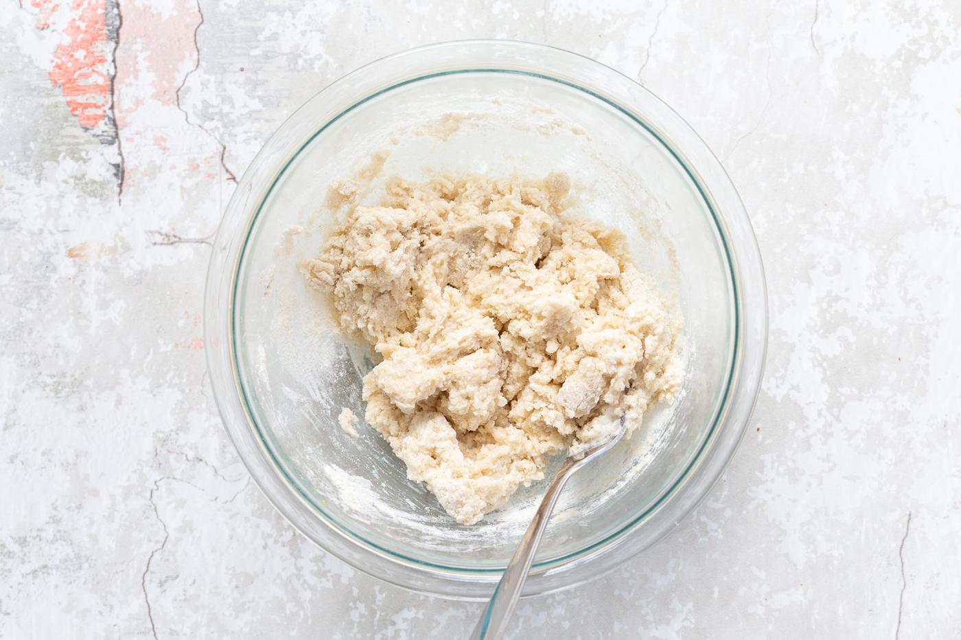 Dough in a glass bowl for the biscuit topping of our Vegan Blueberry Cobbler
