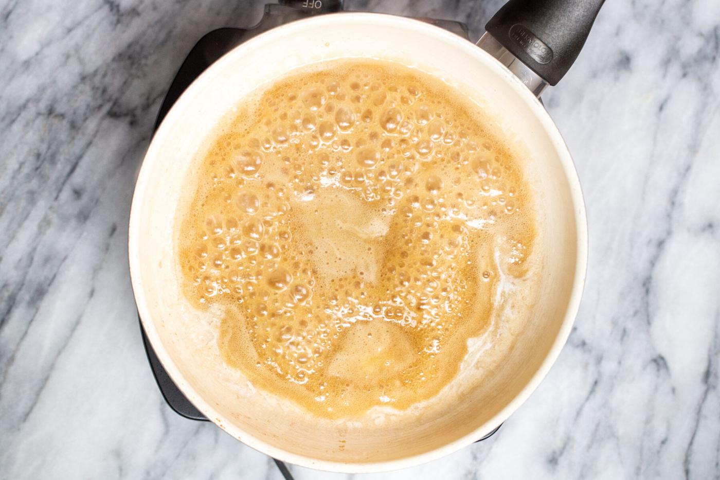 maple syrup and melted coconut cream simmering in a pan