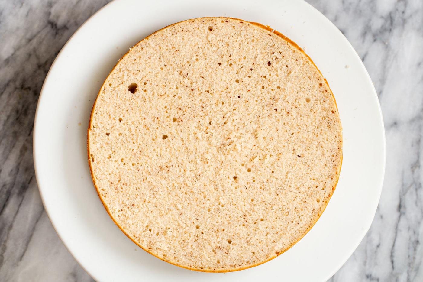 sliced open sponge cake on a cake stand