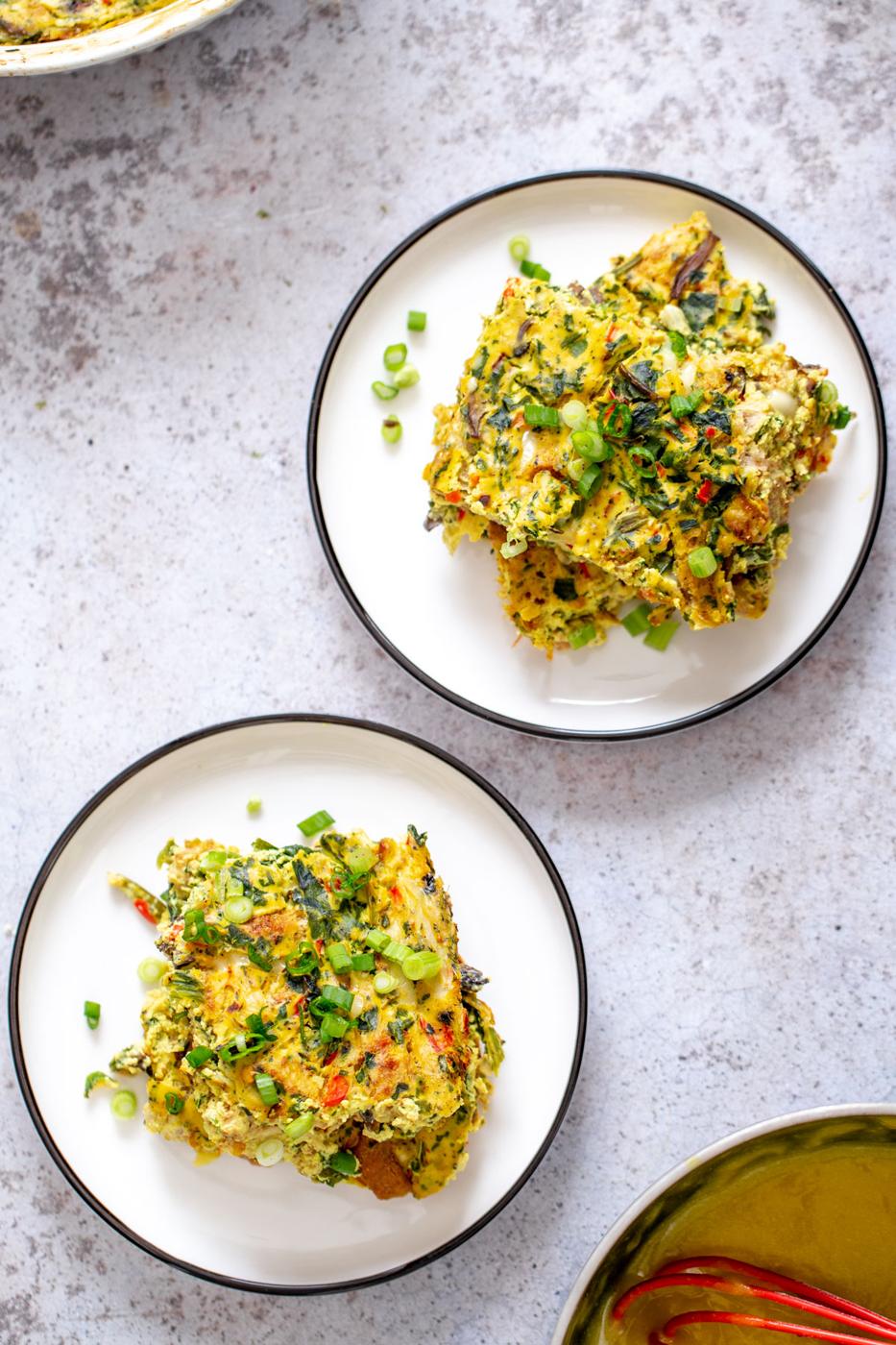 two servings of vegan breakfast casserole sprinkled with green onions