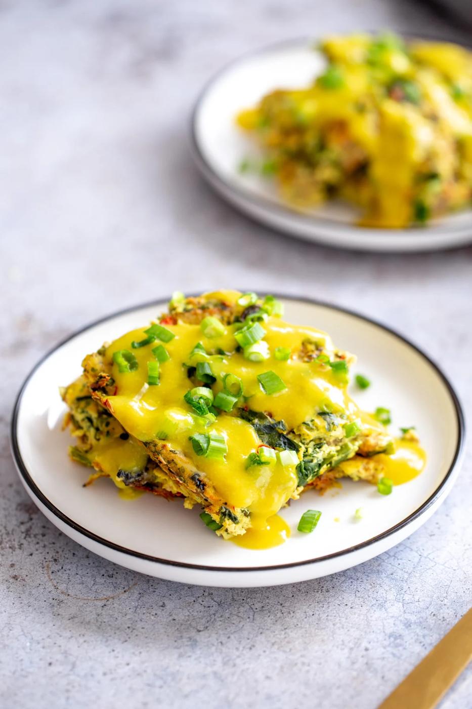 overhead shot of a serving of vegan breakfast casserole served with vegan hollandaise