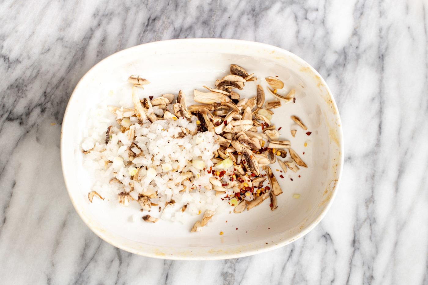 chopped mushrooms and onions in a casserole dish