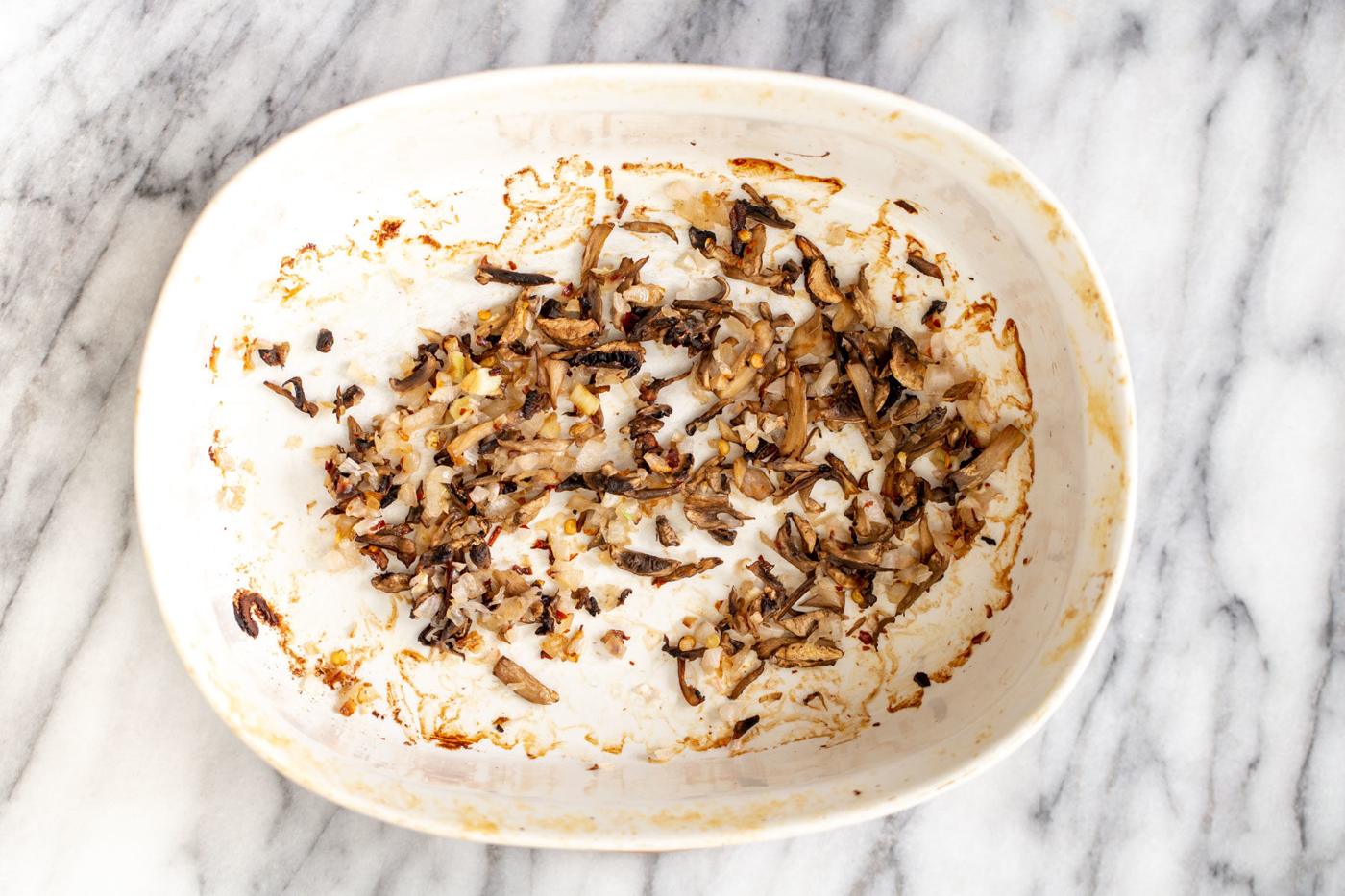 baked mushrooms and onions in a casserole dish