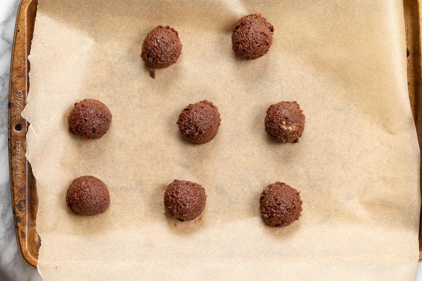 Vegan Brownie Cookie Dough scoop on parchment lined sheet