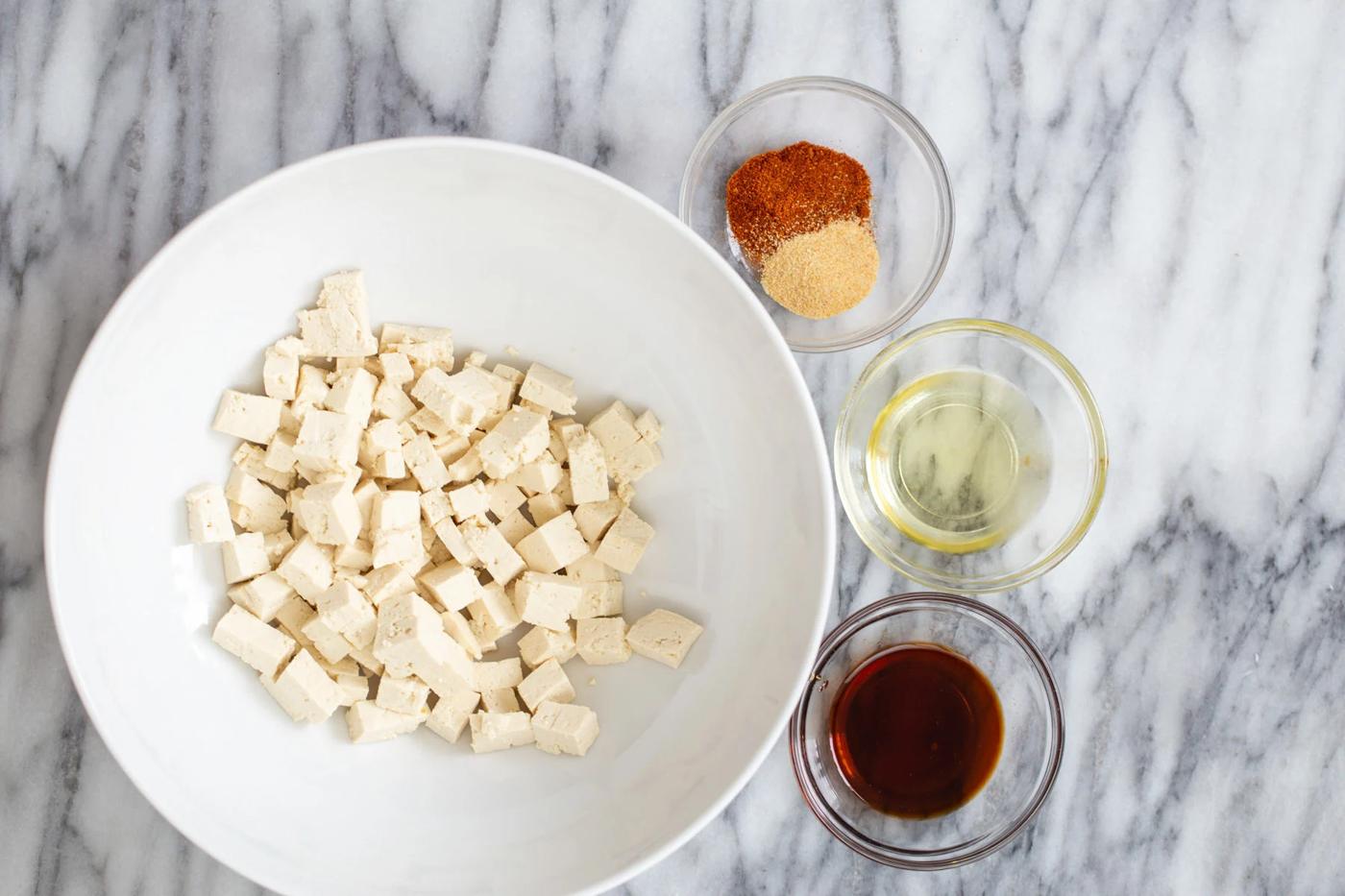 tofu cubes with condiments for making roasted crispy tofu as pasta topping
