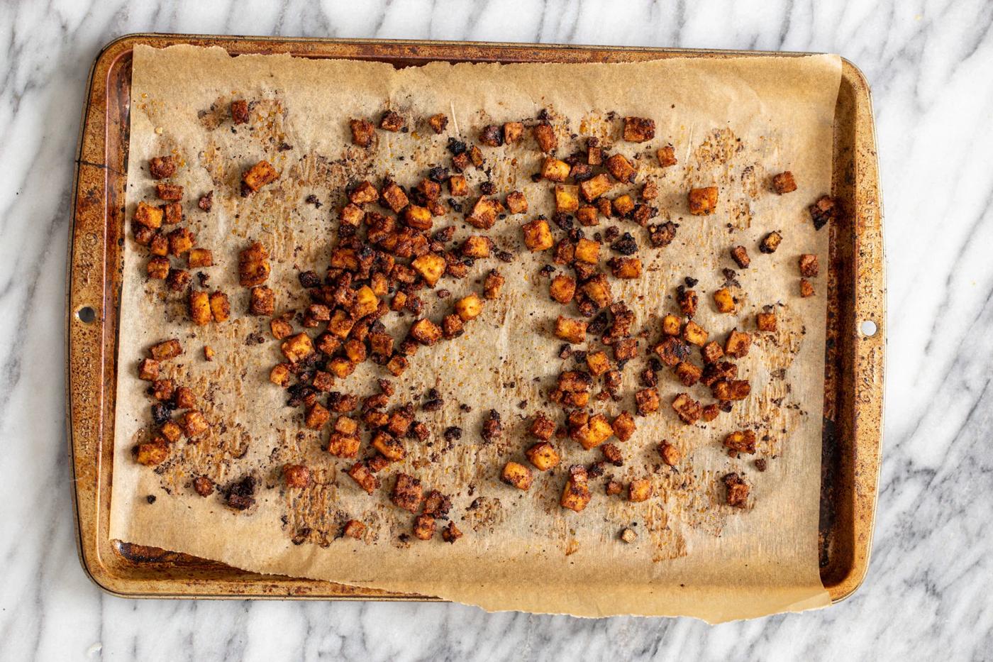 crispy smokey oven roasted tofu cubes on a baking sheet