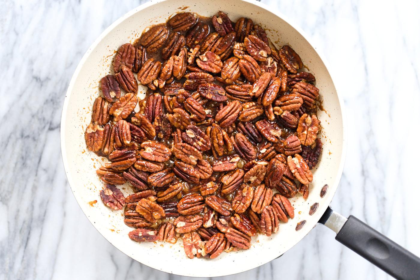 Toasted Pecans in a white skillet