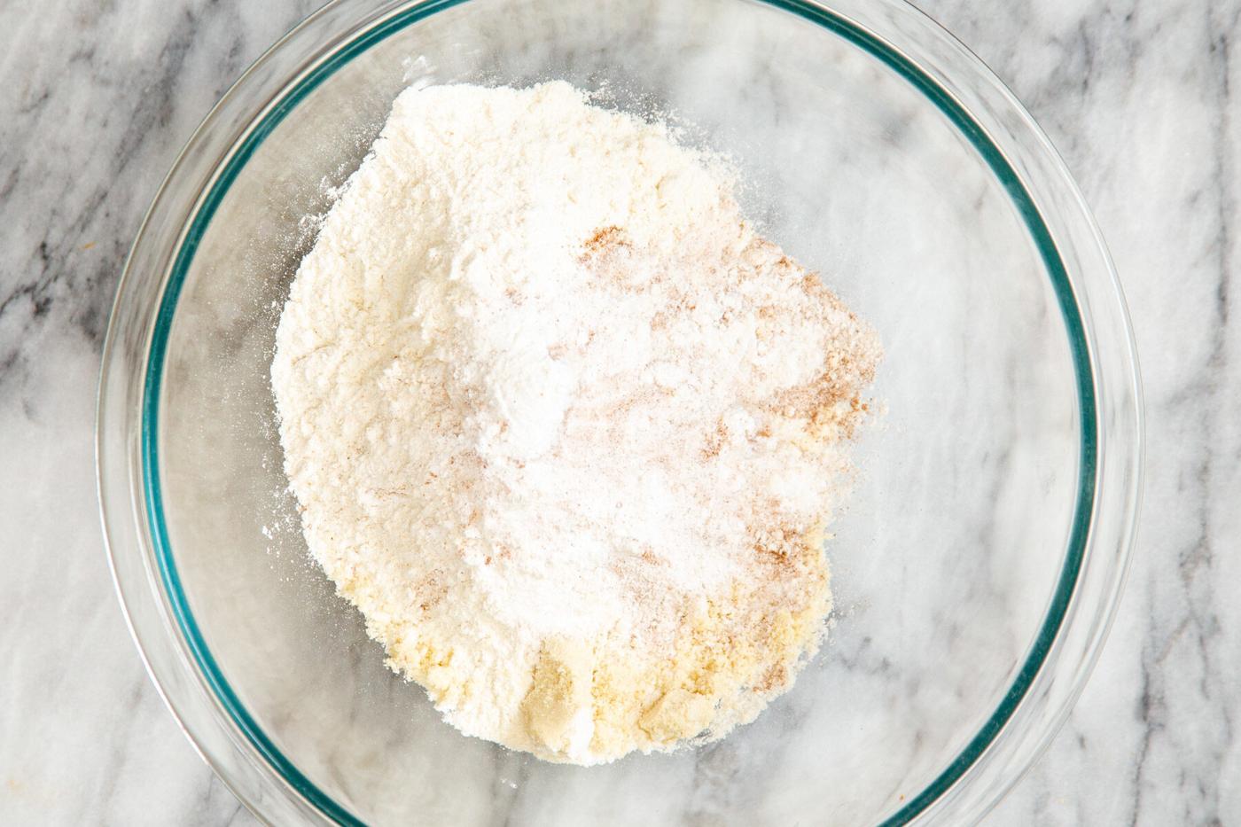 dry carrot cake ingredients in a glass mixing bowl