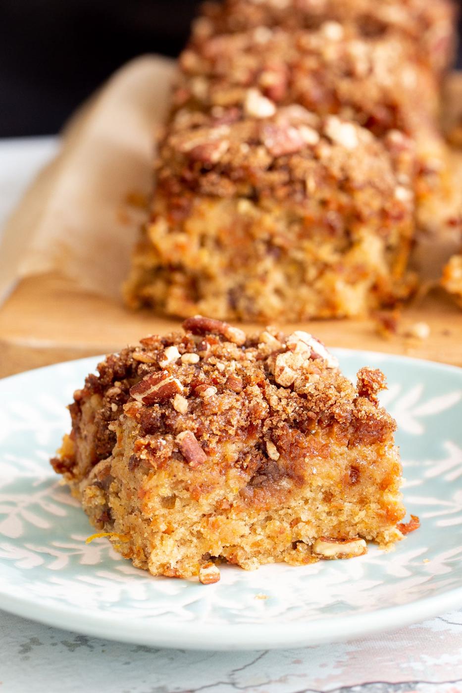 a piece of vegan carrot cake with caramelized carrots on a cake plate