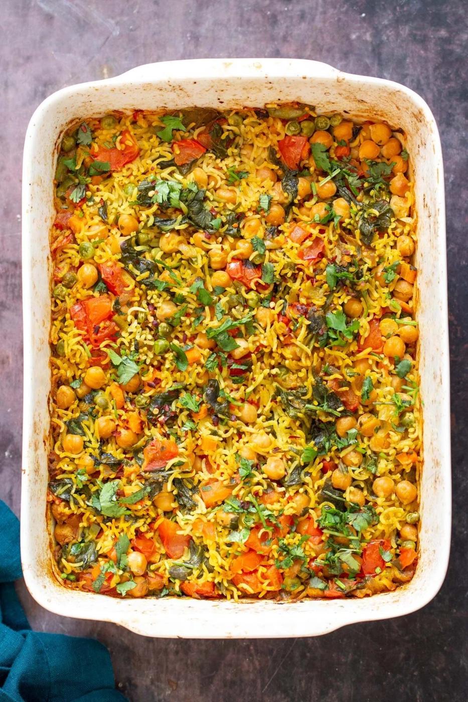 a white casserole dish with vegan chickpea rice pulao