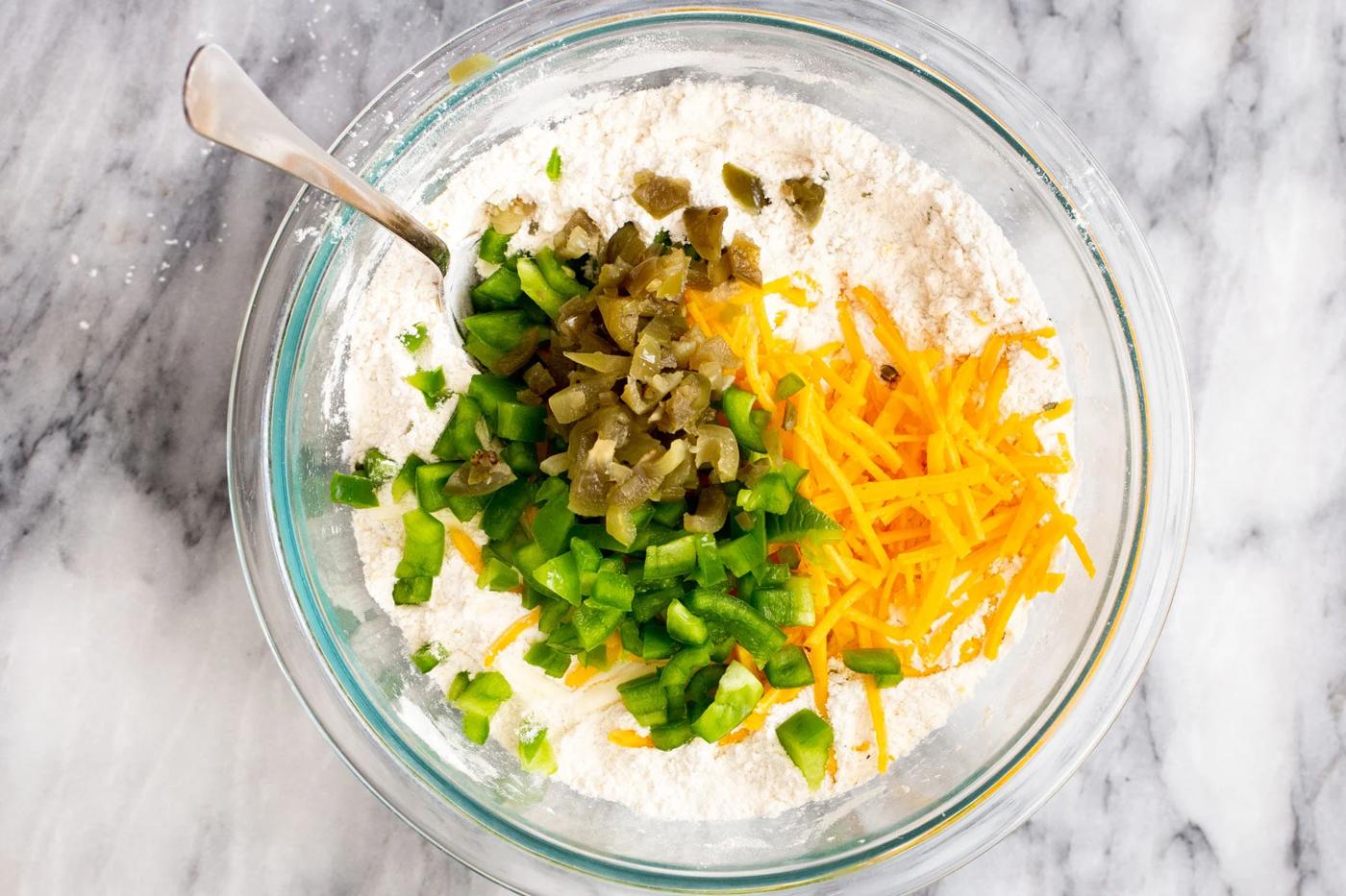 jalapenos and vegan cheddar being added to dry waffle mix