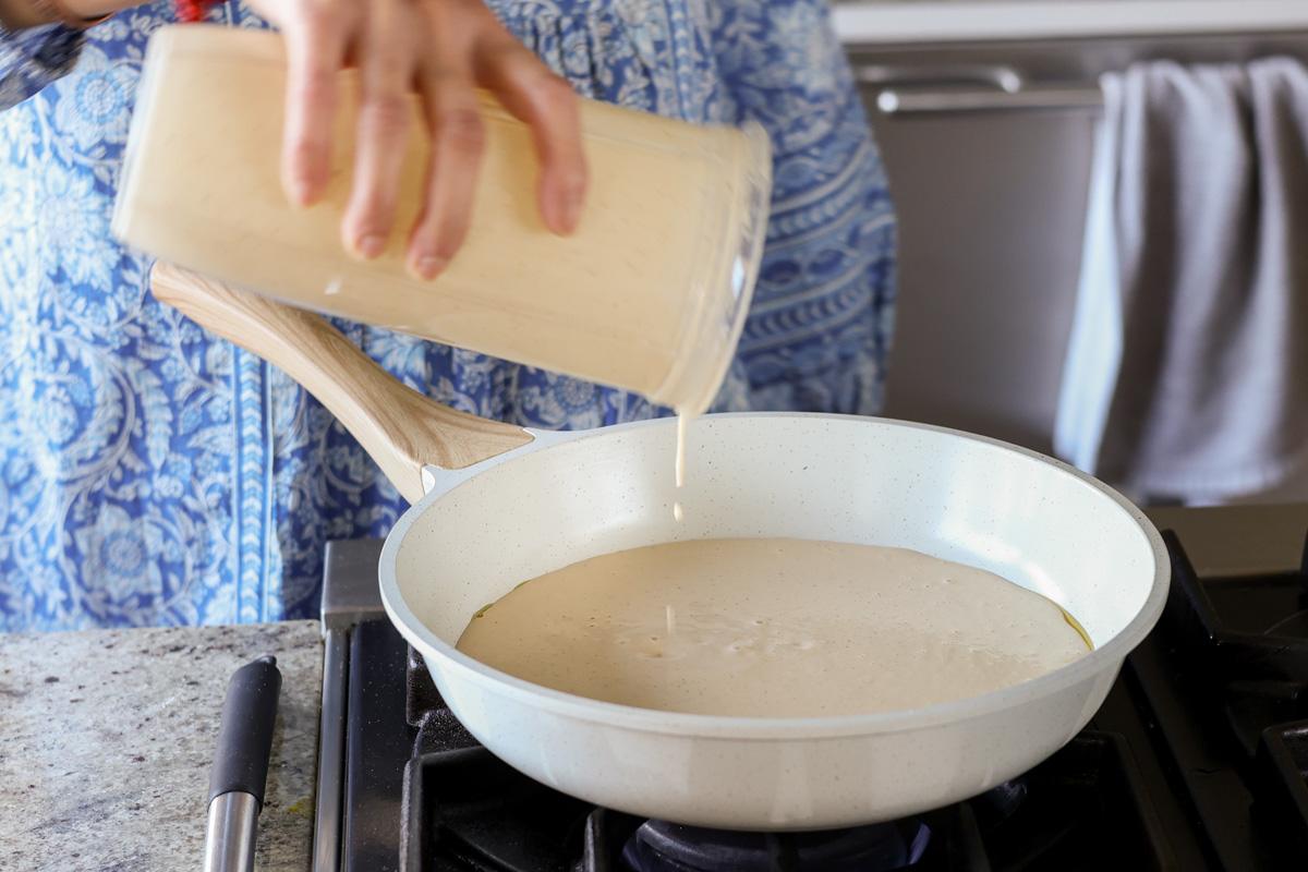 adding the blended cashew mixture to the pan