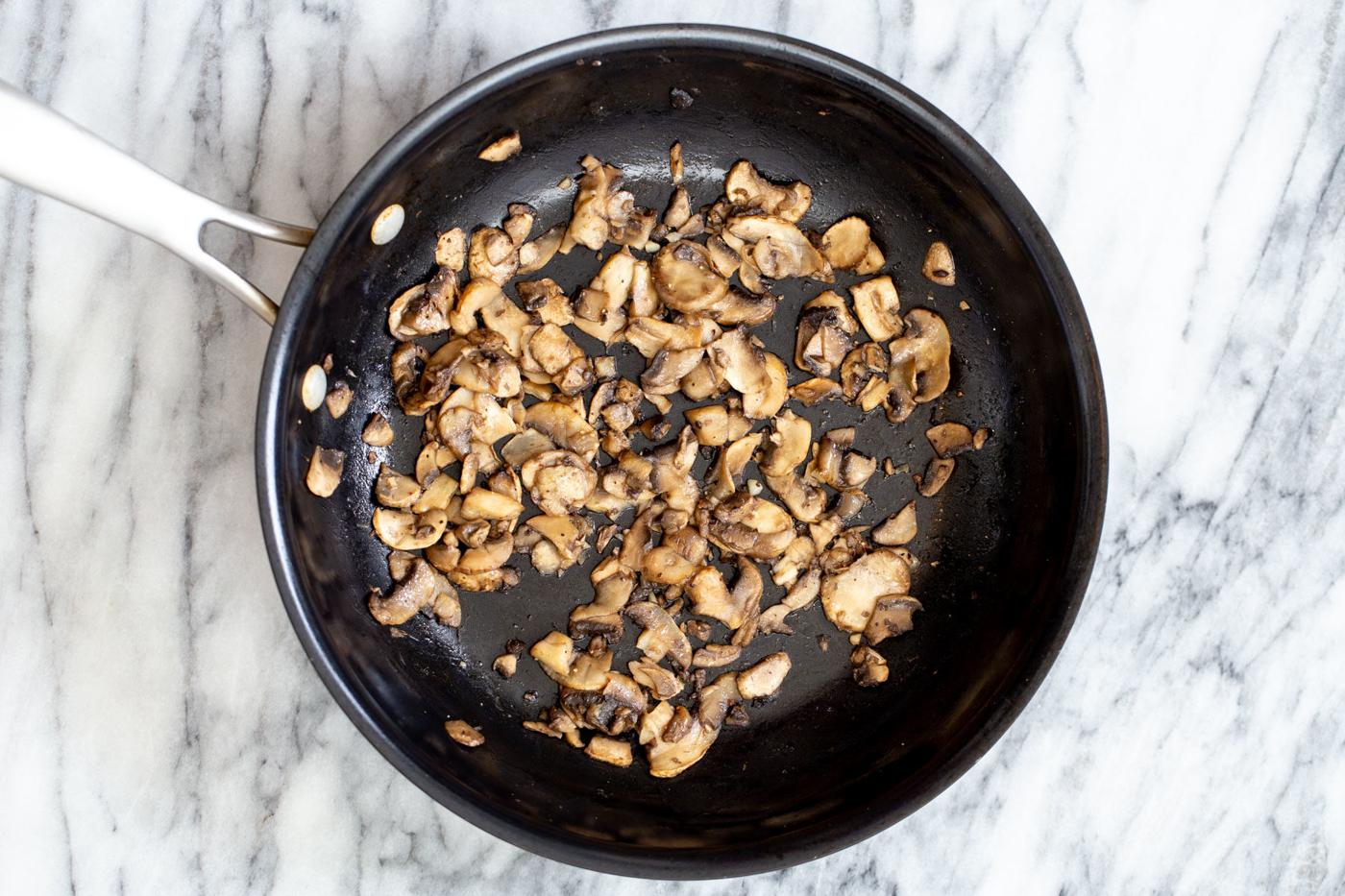 sauteed mushrooms in a frying pan