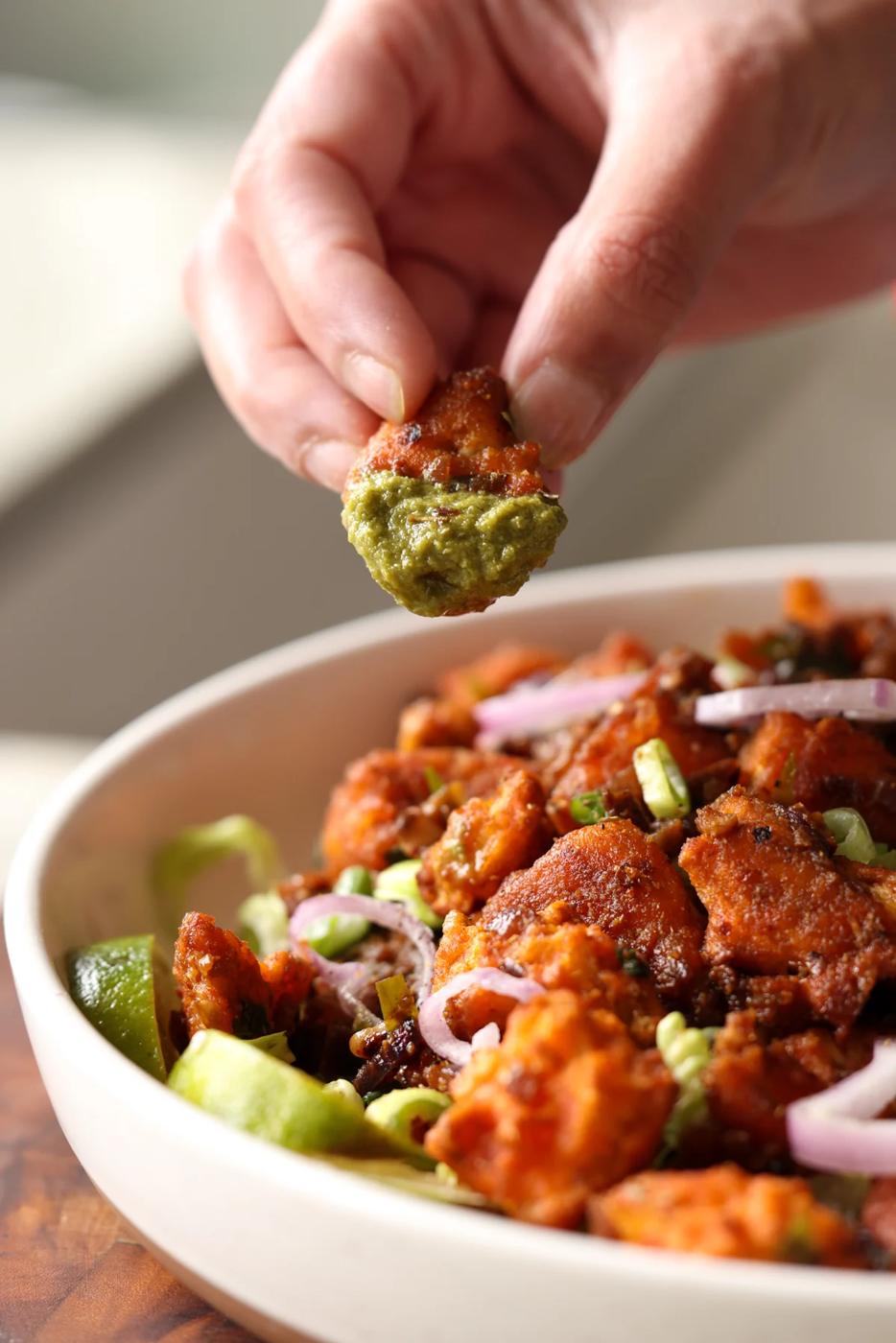 piece of tofu 555 dipped in cilantro mint chutney
