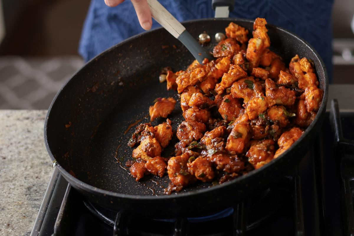 tossing vegan chicken 555 in the sauce
