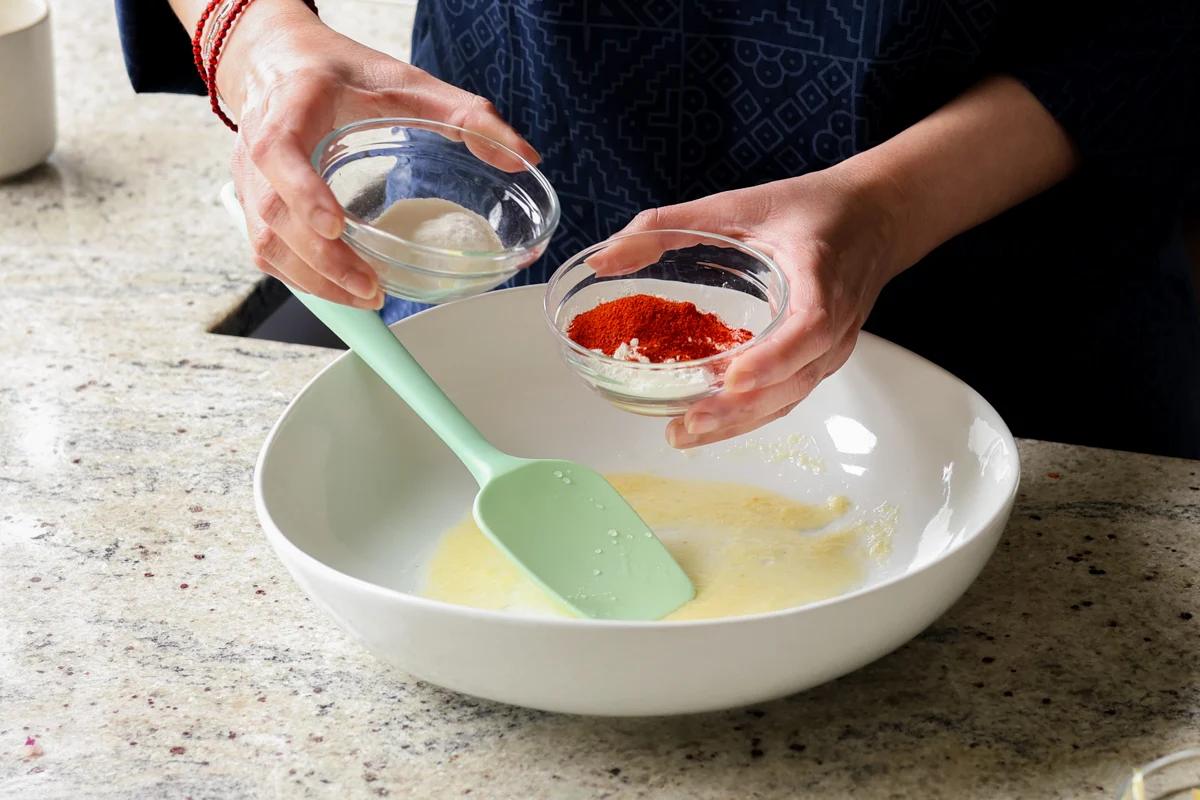 adding cornstarch and spices to a small bowl