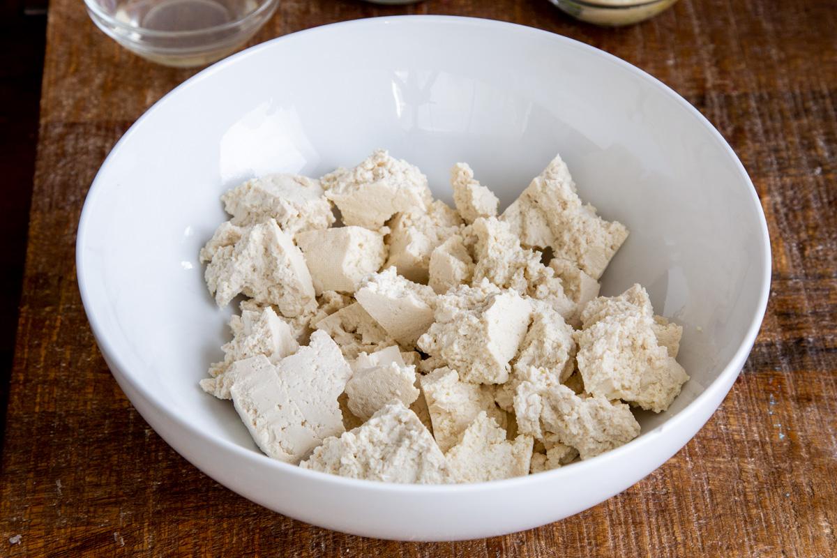 torn up tofu in a white bowl