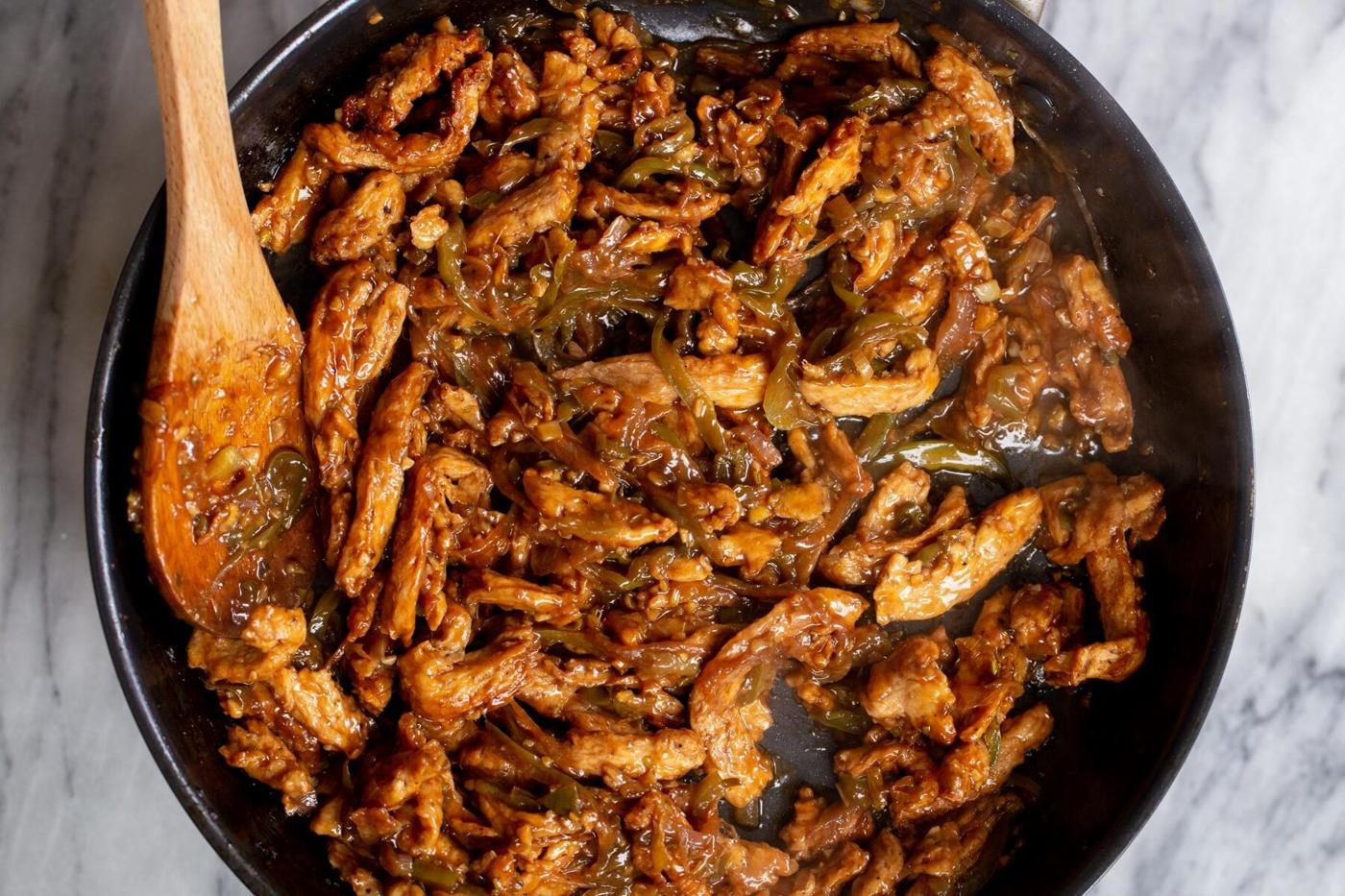 baked soy curls being tossed in green chilli sauce